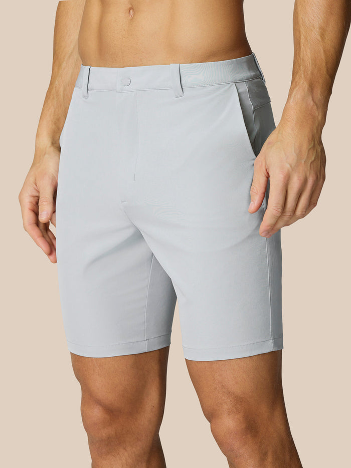 Front view of light gray golf shorts with belt loops