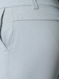 Close-up of light gray golf shorts fabric with water droplets and ProTek logo