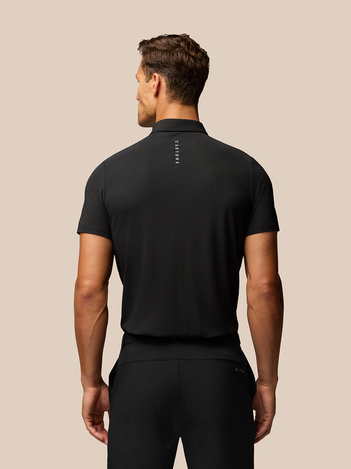 Back view of the black Golf Club Essential Polo showing vertical Castore branding along the back