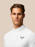 Back view of white golf polo on a male model with Castore branding along the back