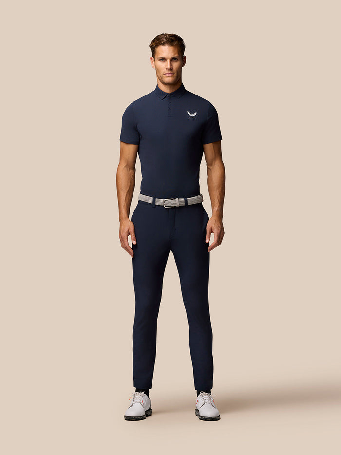 Back shoulder close-up of navy Golf Club Essential Polo highlighting vertical CASTORE branding.