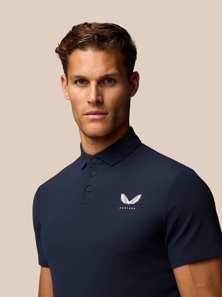 Front view of navy Golf Club Essential Polo for men with Castore logo on left chest and three-button placket.