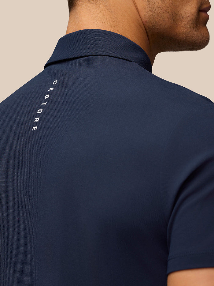 Back view of navy Golf Club Essential Polo for men with Castore branding on upper back.