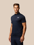 Side profile of a man wearing navy striped Pinnacle Pique Polo with logo on the chest