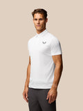 Male model wearing white striped golf polo with Castore logo on left chest and upper back