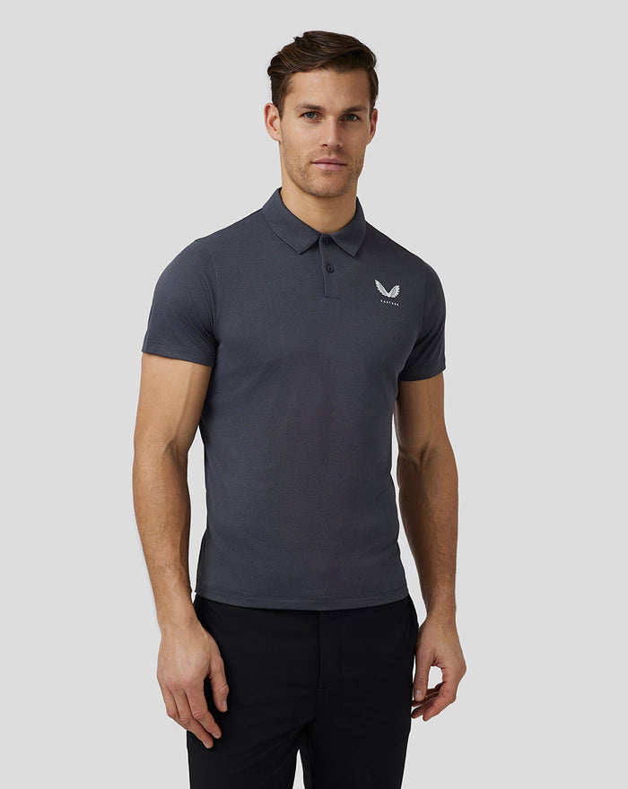 Male model in a dark gray Castore Golf Pinnacle Engineered Polo