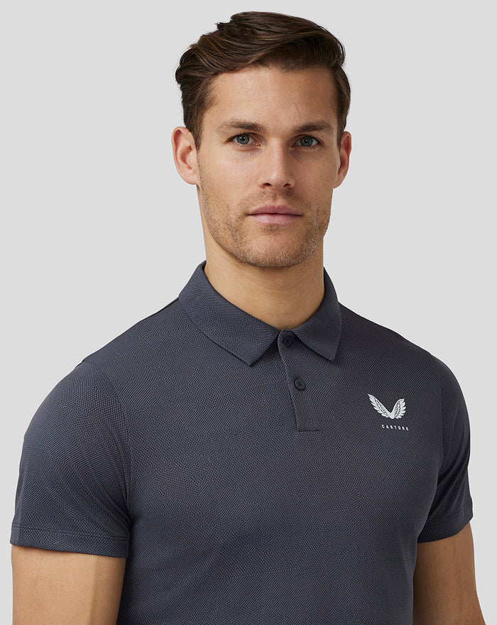 Close up of the textured gray Castore Golf Pinnacle Engineered Polo with chest logo
