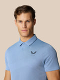 Portrait of a man wearing the light blue Golf Pinnacle Polo with a polo collar and breathable knit fabric