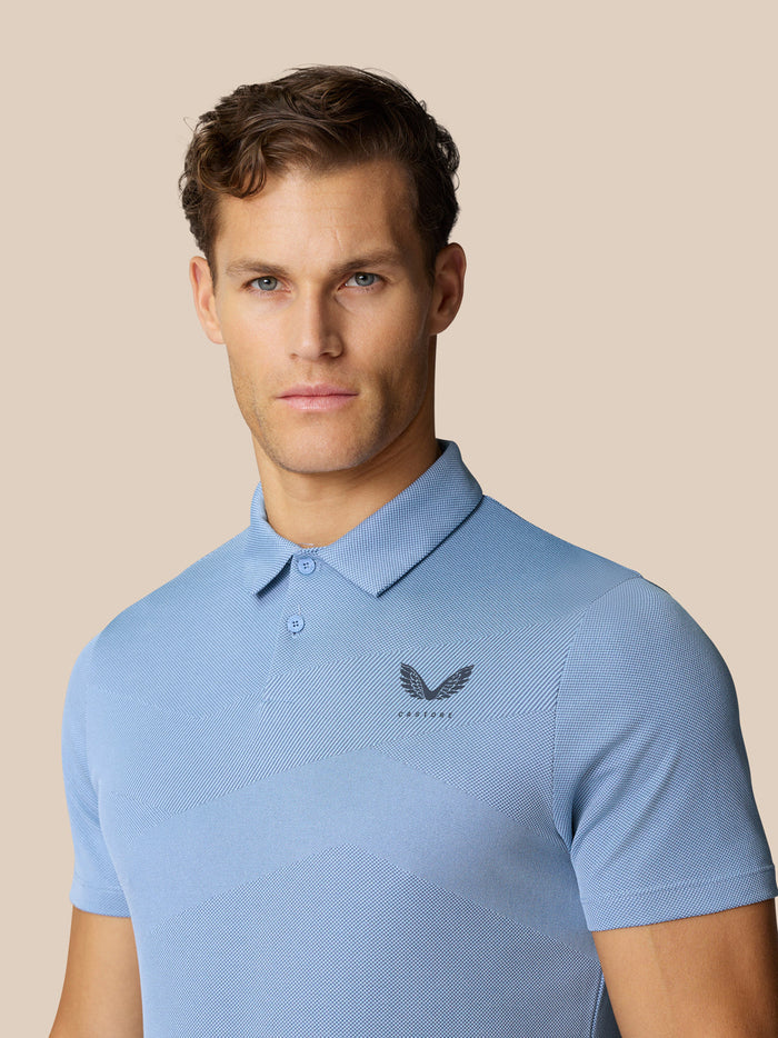 Portrait of a man wearing the light blue Golf Pinnacle Polo with a polo collar and breathable knit fabric