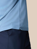 Close up of the light blue knitted fabric showing the textured weave and hem edge of the Golf Pinnacle Polo