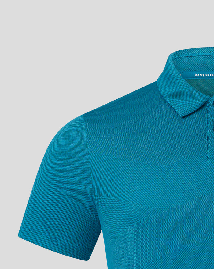 Close-up of teal Pinnacle engineered knit golf polo showing the collar and textured fabric with Castore branding on the chest