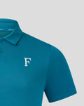 Close up of teal knit polo shoulder showing textured fabric and the white F logo on the chest