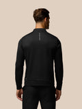 Back view of black golf top showing Castore branding along the upper back