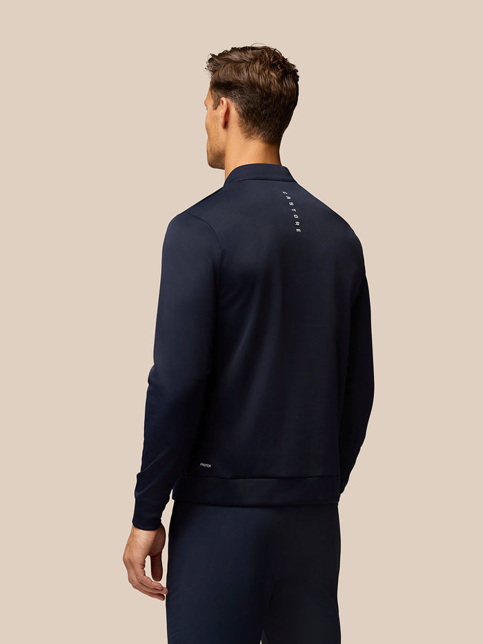 Back view of navy Golf Club Classic top with vertical Castore branding down the back.