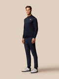 Male model wearing navy Golf Club Classic top with quarter zip and Castore branding on chest.
