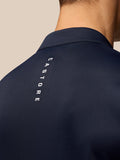 Close up of navy Golf Club top showing vertical Castore branding along the back shoulder.