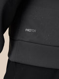 Close up of black Protek fabric with water droplets on a Castore golf top