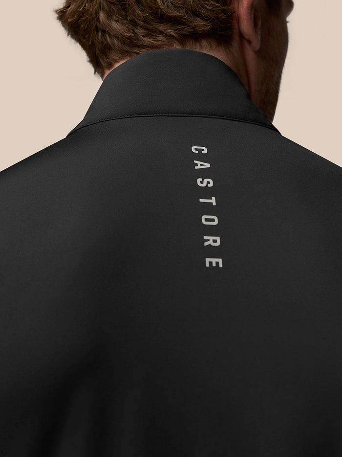 Back view of a black Golf Pinnacle Gilet showing vertical Castore branding along the back