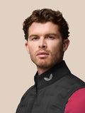 Male model wearing black Golf Pinnacle Gilet with a stand collar and Castore logo on the collar