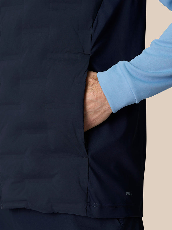 Close up of navy Golf Pinnacle Gilet showing side pocket and Protek water resistant fabric