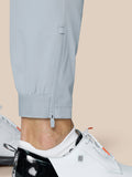 Close up of the pant leg cuff showing ankle zipper and adjustable hem on light grey golf pants