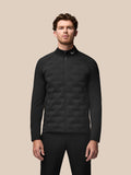 Front view of a male model wearing the black Golf Pinnacle jacket with quilted front panels and full zip