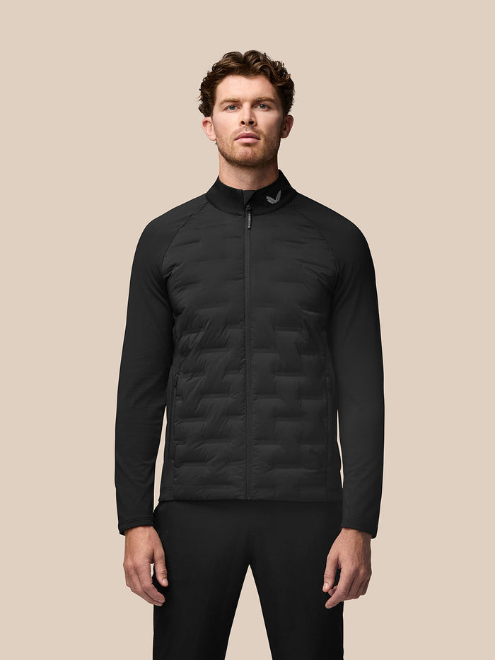 Front view of a male model wearing the black Golf Pinnacle jacket with quilted front panels and full zip