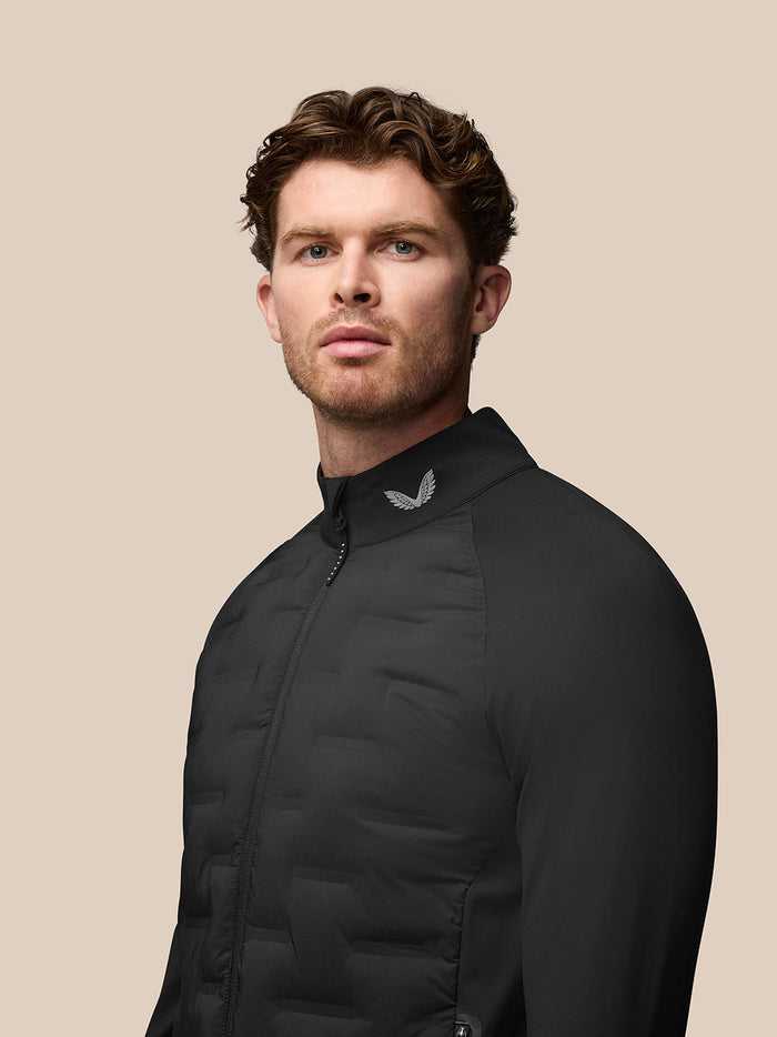 Male model wearing black Golf Pinnacle Jas with stand collar and quilted front panels