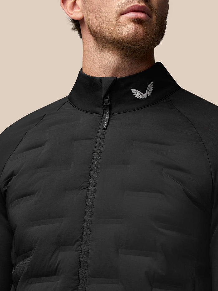 Close-up of the high collar and full zipper of the Golf Pinnacle Jas jacket with a metallic crest on the collar