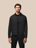 Front view of a man wearing a black Golf Pinnacle Jas jacket with quilted front panels and a full-length zipper