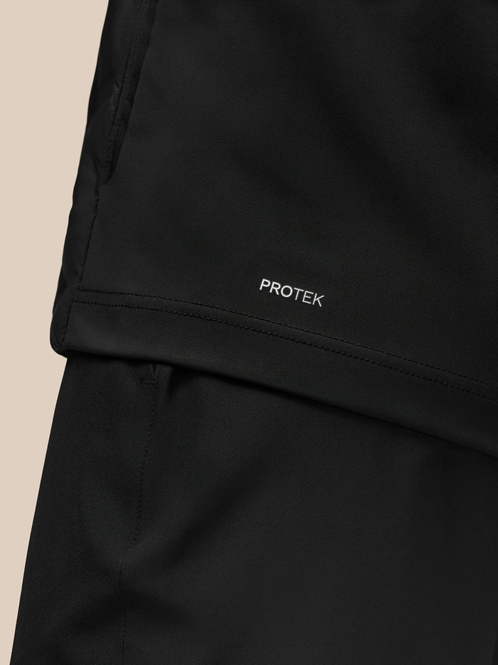 Hem detail of the black Golf Pinnacle Jas showing Protek label