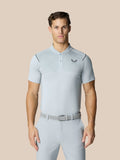 Male model wearing Pinnacle Golf Polo in pale blue gray with diagonal stripe texture and chest logo, paired with light gray pants.