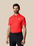 Man wearing red graphic golf polo with golf ball pattern and a pointed collar