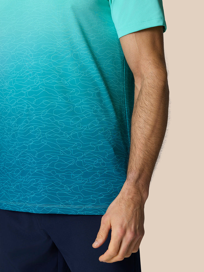 Man draagt Club Grafische Polo Licht Aqua met ombre grafische print en korte mouwen.
