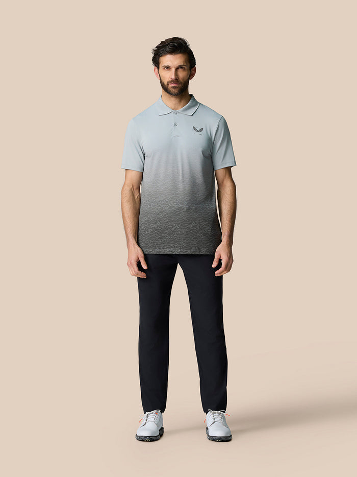 Male model wearing Club Grafische Polo in light gray with an ombre graphic and Castore logo on the chest.
