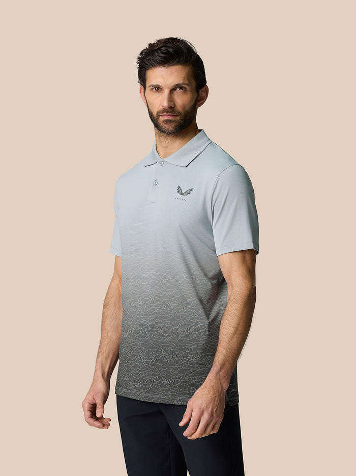 Male model wearing Club Grafische Polo in mid gray with an ombre graphic and Castore logo on the chest.