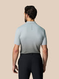 Back view of a model in the light gray polo showing the Castore logo on the upper back