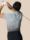 Back view of a golfer wearing a light blue Club Grafische Polo with an ombre print and CASTORE branding on the upper back