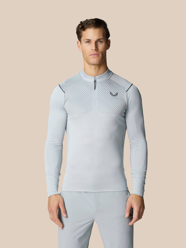 Light grey Pinnacle quarter zip golf top with diagonal chest pattern and Castore logo.