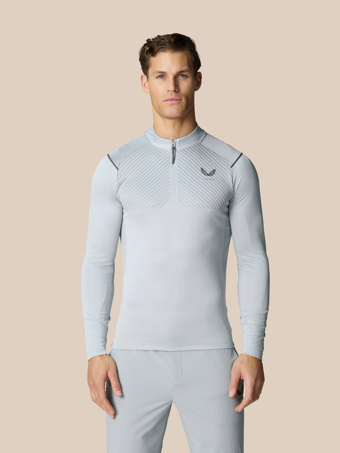 Light grey Pinnacle quarter zip golf top with diagonal chest pattern and Castore logo.