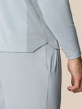 Close up of the back hem and vent panel on the light gray LVS golf top