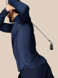 Man in navy golf quarter zip top mid swing showing ventilated panels and ProTek water resistance
