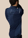 Back view of man wearing navy Castore LVS golf top with striped back panel for ventilation
