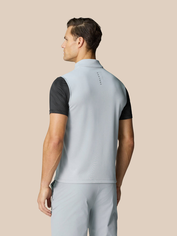 Back view of a light grey Club Halve Zip Gilet on a model with Castore branding at the neck and a black dotted underlayer