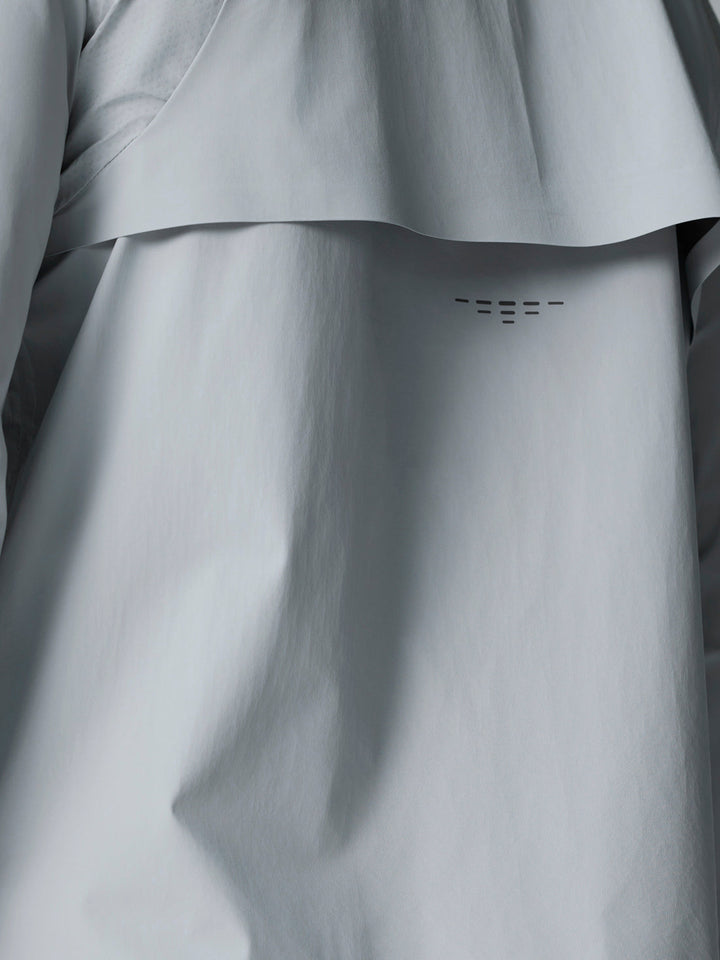 Back view of light gray Golf Pinnacle woven jacket showing a curved back panel detail.