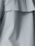 Back view of light gray Golf Pinnacle woven jacket showing a curved back panel detail.
