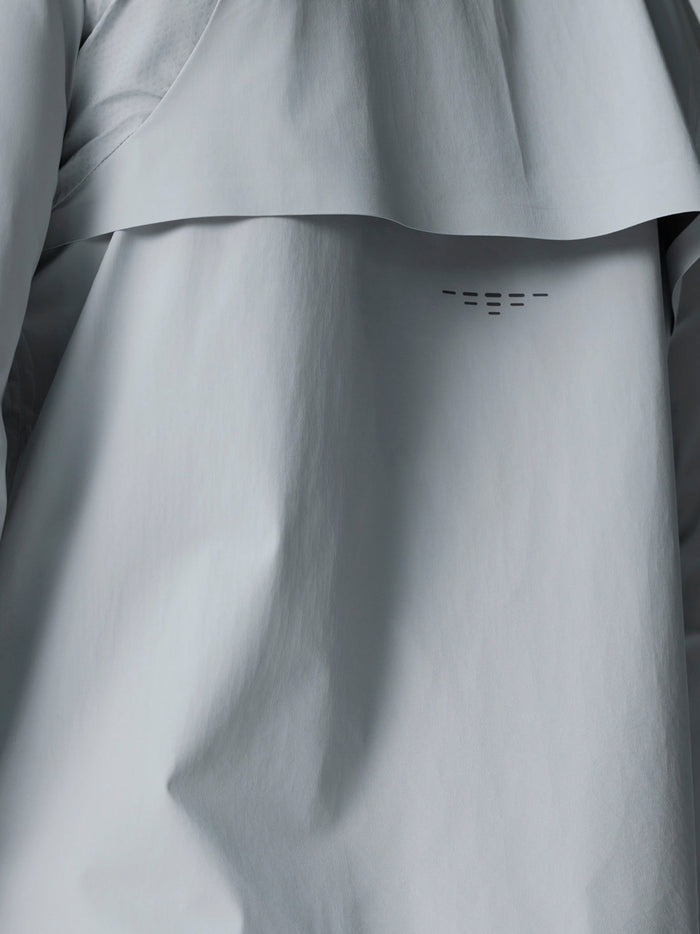 Back view of light gray Golf Pinnacle woven jacket showing a curved back panel detail.