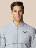 Front view of a man wearing a light gray Golf Pinnacle woven jacket.