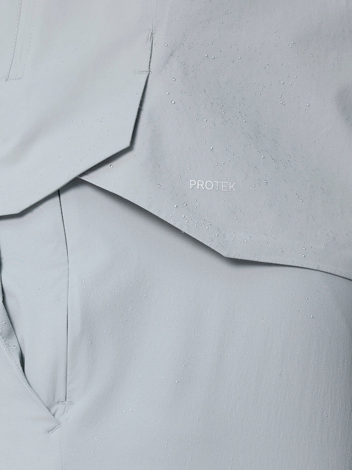 Close-up of light gray ProTek fabric with water droplets and ProTek logo.