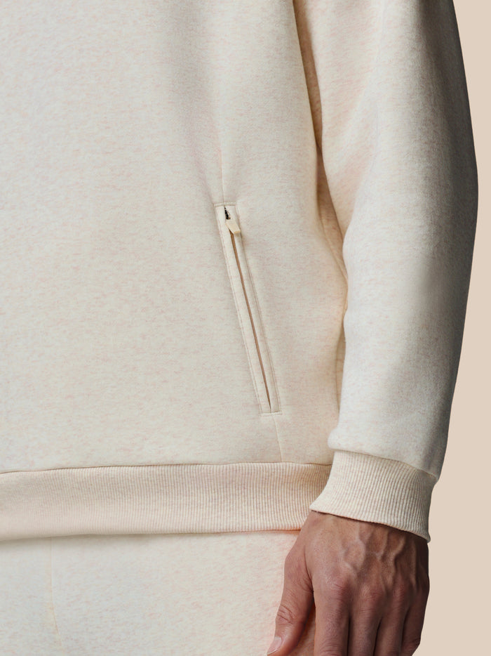 Close up of side zipper pocket on oatmeal fleece hoodie with ribbed hem